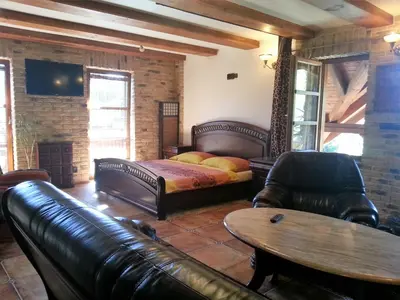 a living room with a couch and a bed and a table at Ubytování Steak-Hredle in Hředle