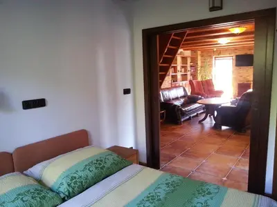 a bedroom with a bed and a living room at Ubytování Steak-Hredle in Hředle