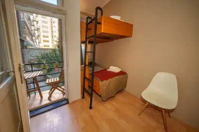 a room with a bunk bed and a chair and a window at Dlouhá Apartment with balcony in Prague