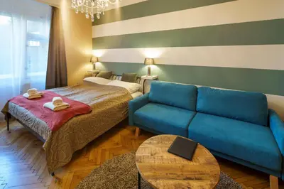 a living room with a couch and a bed at Dlouhá Apartment with balcony in Prague