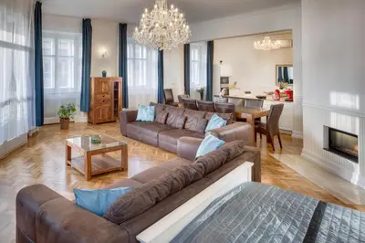 a large living room with a couch and a table at Smetanovo nábřeží - Riverview Old Town Apartment in Prague