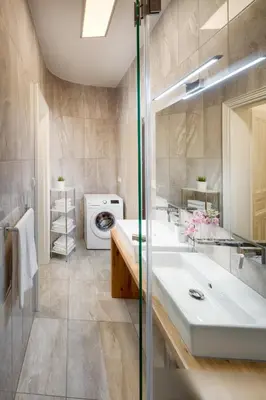 a bathroom with two sinks and a washing machine at Smetanovo nábřeží - Riverview Old Town Apartment in Prague