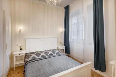a bedroom with a bed and a window at Smetanovo nábřeží - Riverview Old Town Apartment in Prague