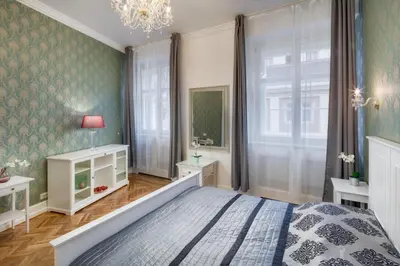 a bedroom with a bed and a large window at Smetanovo nábřeží - Riverview Old Town Apartment in Prague