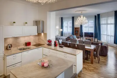 a kitchen and living room with a dining room at Smetanovo nábřeží - Riverview Old Town Apartment in Prague