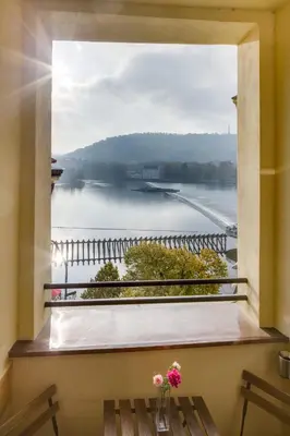 a window with a view of the water at Smetanovo nábřeží - Riverview Old Town Apartment in Prague