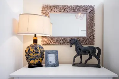 a table with a lamp and a horse statue on it at Bear Fountain Residence in Prague