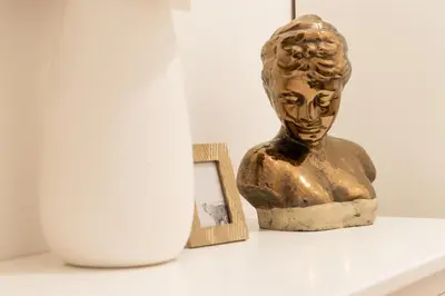 a bust of a woman sitting on a shelf next to a vase at Bear Fountain Residence in Prague
