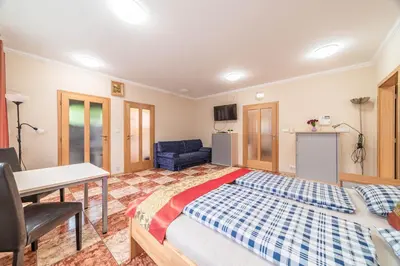 a bedroom with a bed and a desk and a table at Apartmán blizko centra Prahy in Prague