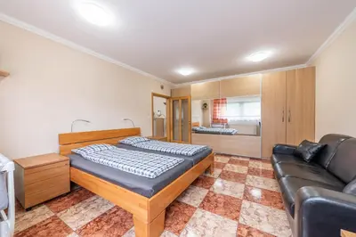 a bedroom with a bed and a couch at Apartmán blizko centra Prahy in Prague