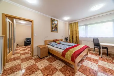 a bedroom with a bed and a desk and a window at Apartmán blizko centra Prahy in Prague