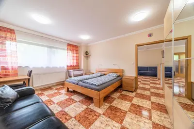 a bedroom with a bed and a couch at Apartmán blizko centra Prahy in Prague
