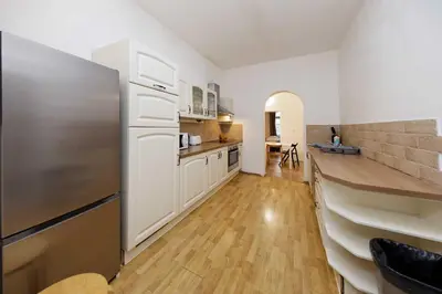 a kitchen with white cabinets and a sink at Borivojova 50 in Prague