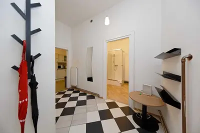 a room with a cross on the wall and a table at Borivojova 50 in Prague