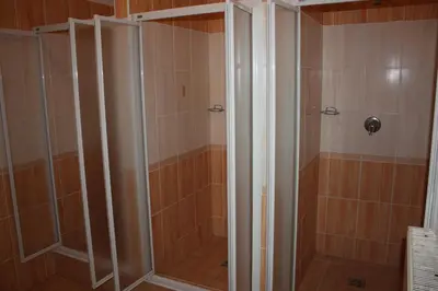 a shower with a glass door in a bathroom at Sporthotel BK Pod Lipou in Roudnice nad Labem