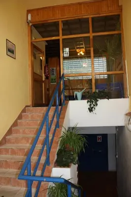 a staircase in a building with blue railing and plants at Sporthotel BK Pod Lipou in Roudnice nad Labem