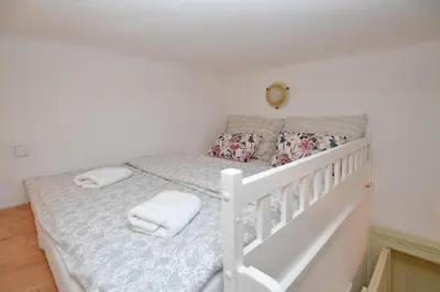 a white bed with two pillows on it in a room at Lovely little cosy Apt in Prague in Prague