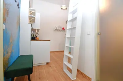 a small kitchen with a ladder in a small room at Lovely little cosy Apt in Prague in Prague