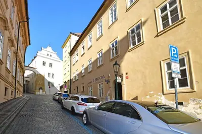 a street with cars parked on the side of a building at Lovely little cosy Apt in Prague in Prague
