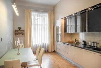 a kitchen with a table and a dining room at Mordecai 12 Apartments by Adrez in Prague