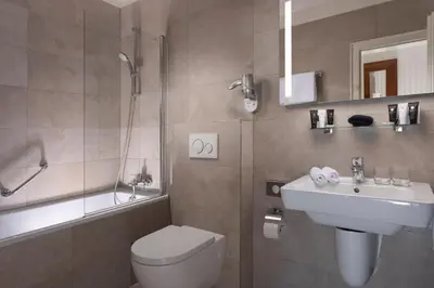a bathroom with a toilet and a sink and a shower at Hotel Pod Věží in Prague