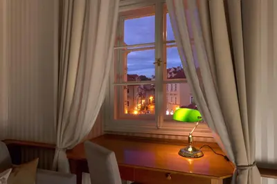 a window with a table and a lamp on a table at Hotel Pod Věží in Prague
