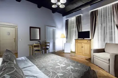 a living room with a bed and a couch at Hotel Pod Věží in Prague