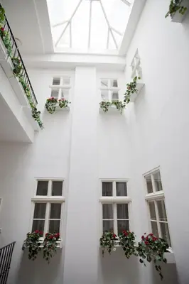 a white building with windows and flowerpots at Hotel Pod Věží in Prague