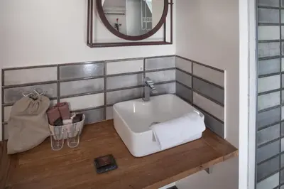 a bathroom with a sink and a mirror at Antik Hotel Prague in Prague
