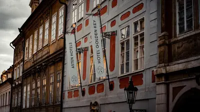 a building with a sign on the side of it at Hotel Golden Key Prague Castle in Prague
