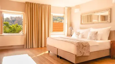 a bedroom with a large bed and a window at Hotel Golden Key Prague Castle in Prague