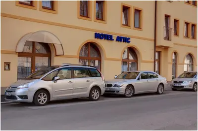 three cars parked in front of a building at Attic Hotel in Prague