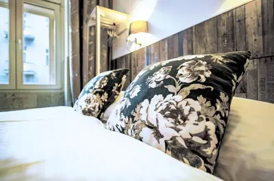 a bedroom with a bed and pillows on it at Royal Court Hotel in Prague