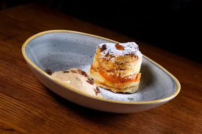 a piece of cake in a bowl on a table at Hotel Oya in Prague