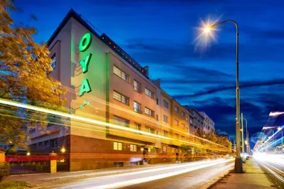 a building with a sign on the side of a street at Hotel Oya in Prague