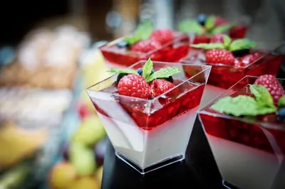 a group of four deserts with strawberries in them at Friday Hotel in Prague