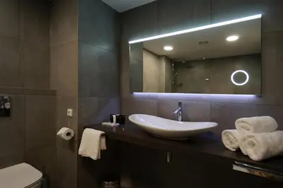 a bathroom with a sink and a mirror at Friday Hotel in Prague