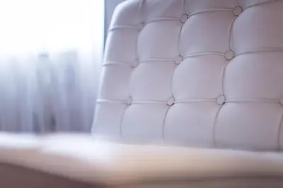 a white couch in a room with a window at Friday Hotel in Prague
