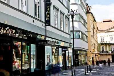 a city street with buildings and a street light at Friday Hotel in Prague