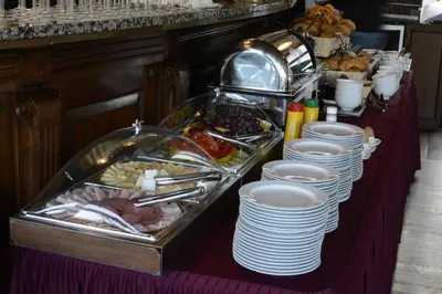 a buffet with plates and food on a table at Boat Hotel Matylda in Prague