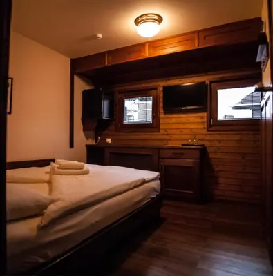 a bedroom with two beds and a tv and a window at Boat Hotel Matylda in Prague