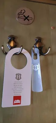 a white door with two handles on a table at Augustus et Otto Hotel in Prague