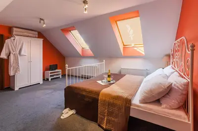 a bedroom with a bed and two skylights at Augustus et Otto Hotel in Prague