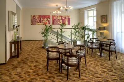 a restaurant with tables and chairs in a room at 1.Republic Hotel in Prague