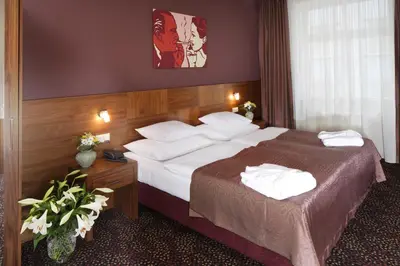 a hotel room with a large bed with white pillows at 1.Republic Hotel in Prague