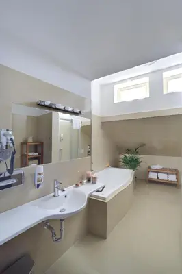 a bathroom with a sink and a large mirror at 1.Republic Hotel in Prague