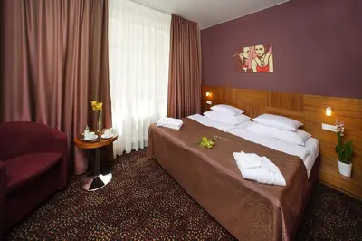 a hotel room with a bed and a chair at 1.Republic Hotel in Prague