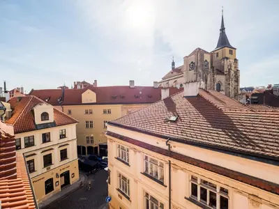 a view of roofs of buildings and a church at Chateau 9 Apartments by Adrez in Prague
