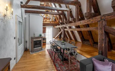 a living room with a table and a fireplace at Chateau 9 Apartments by Adrez in Prague