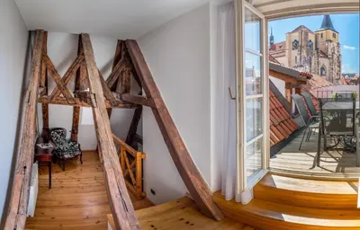 a room with a large window and a wooden floor at Chateau 9 Apartments by Adrez in Prague